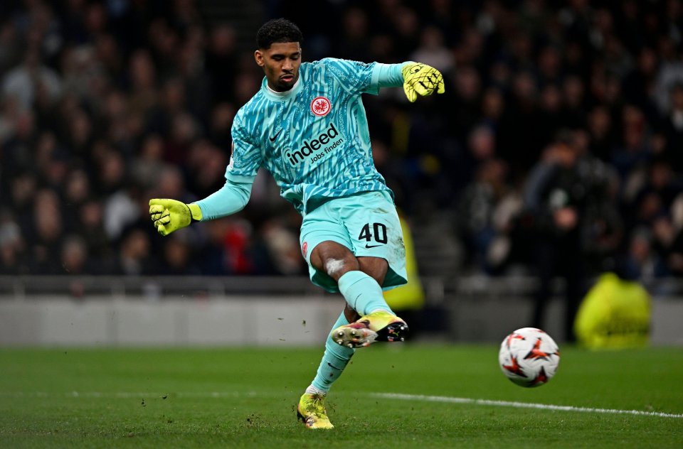 Eintracht Frankfurt goalkeeper Kaua Santos kicking the ball during a soccer match.