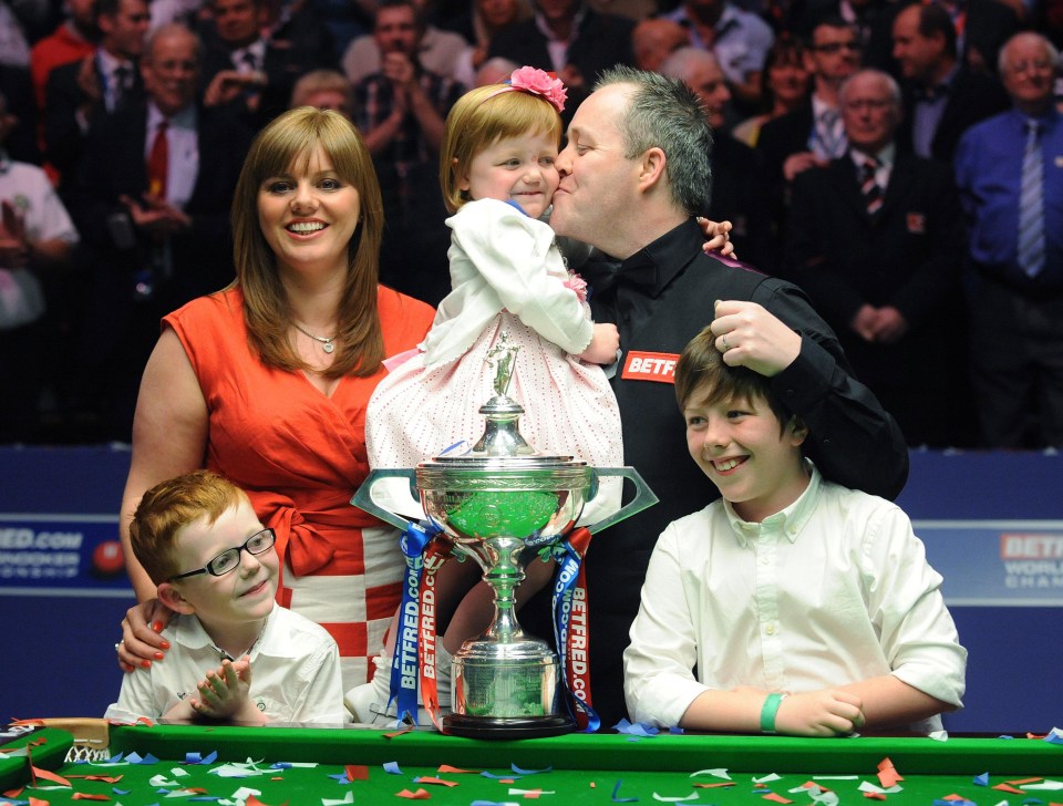 Snooker player John Higgins celebrates his victory with his family.