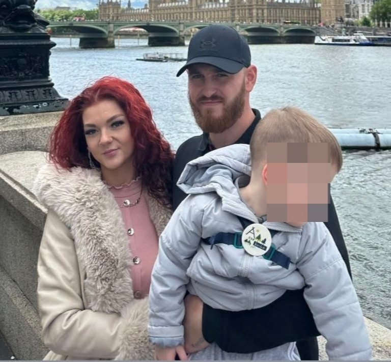 Photo of a young family in London, with the Houses of Parliament in the background.