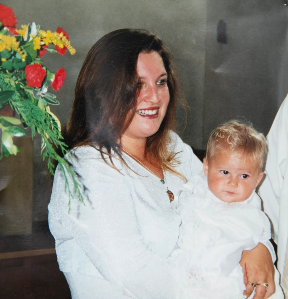 Photo of a mother and her baby at a christening.