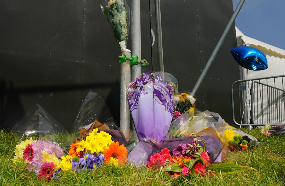 Floral tributes at a festival site.