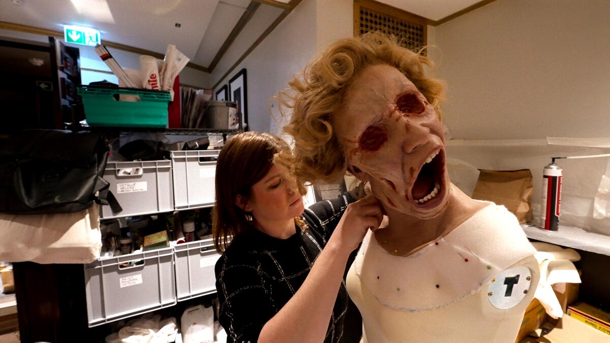 A woman working on a prosthetic head