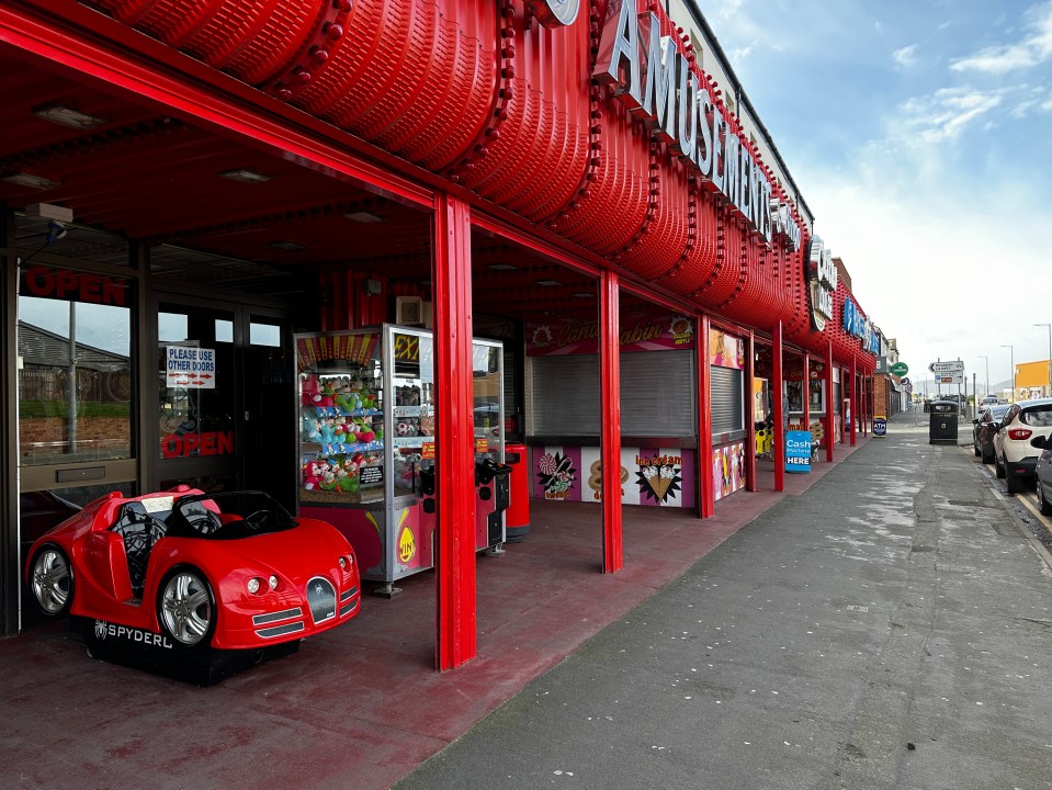 Rhyl seaside amusement arcade with ride and game machines.