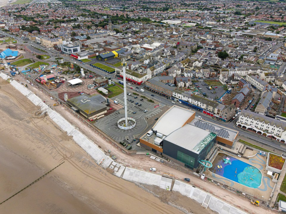 an aerial view of a city with a building that says ' aquatic centre ' on it