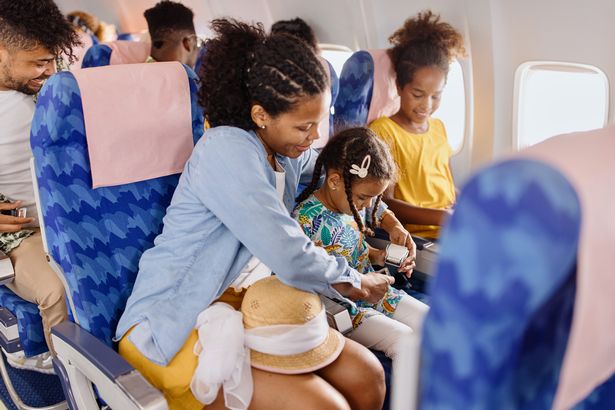 Image of mother and children on board an aircraft
