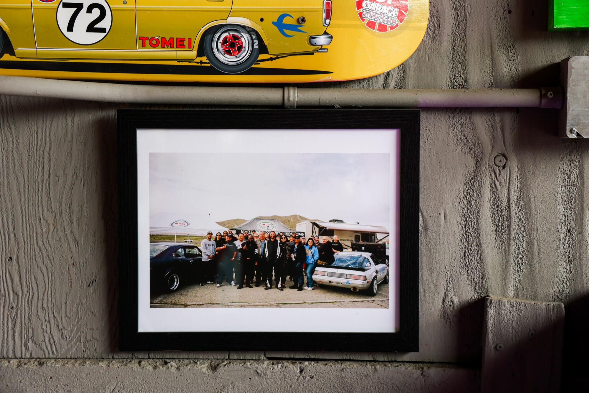 A framed photo of VJMU club members hangs on the wall.