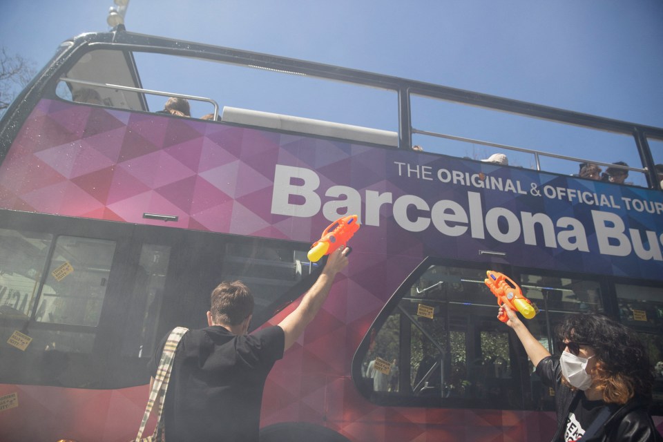 Activists using water guns to stop a Barcelona Bus tour.
