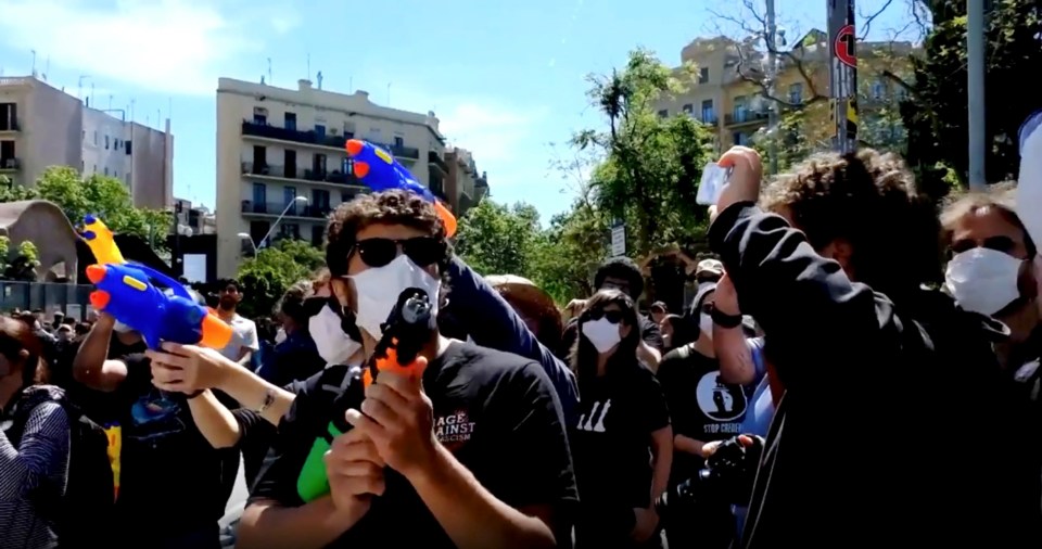 Protestors using water guns during a demonstration.