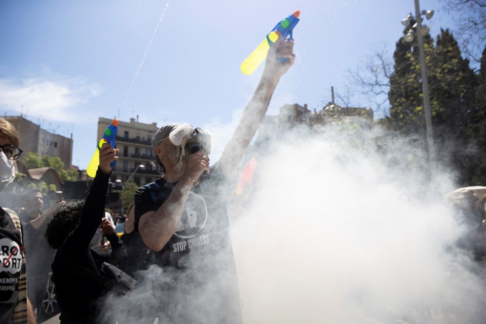 Protestors using water guns and smoke to demonstrate against overtourism.