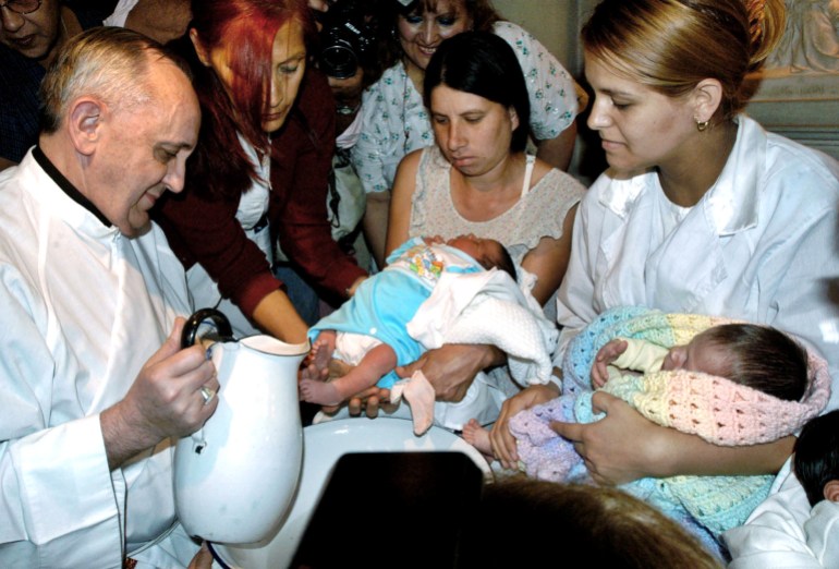 File photo of Argentine Cardinal Bergoglio washing the feet of two newly born children on Holy Thursday. The archbishop of Buenos Aires, Cardinal Jorge Bergoglio, is seen in this file photo washing the feet of two newly born children on Holy Thursday at the Buenos Aires' Sarda maternity hospital on March 24, 2005. Bergoglio is the only Argentine among 117 cardinals entitled to cast a ballot and to be elected in the conclave set to start on April 18 to choose the new pope. Photo taken March 24. REUTERS/Tony Gomez-DyN PP05040051