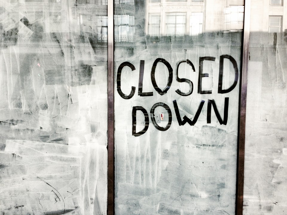 Closed down sign on a store window.