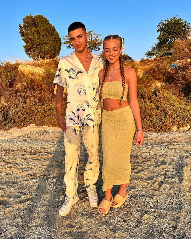 Couple posing outdoors.