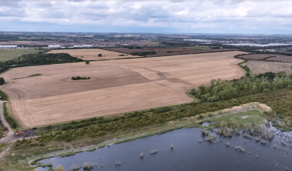Aerial view of farmland and a lake.