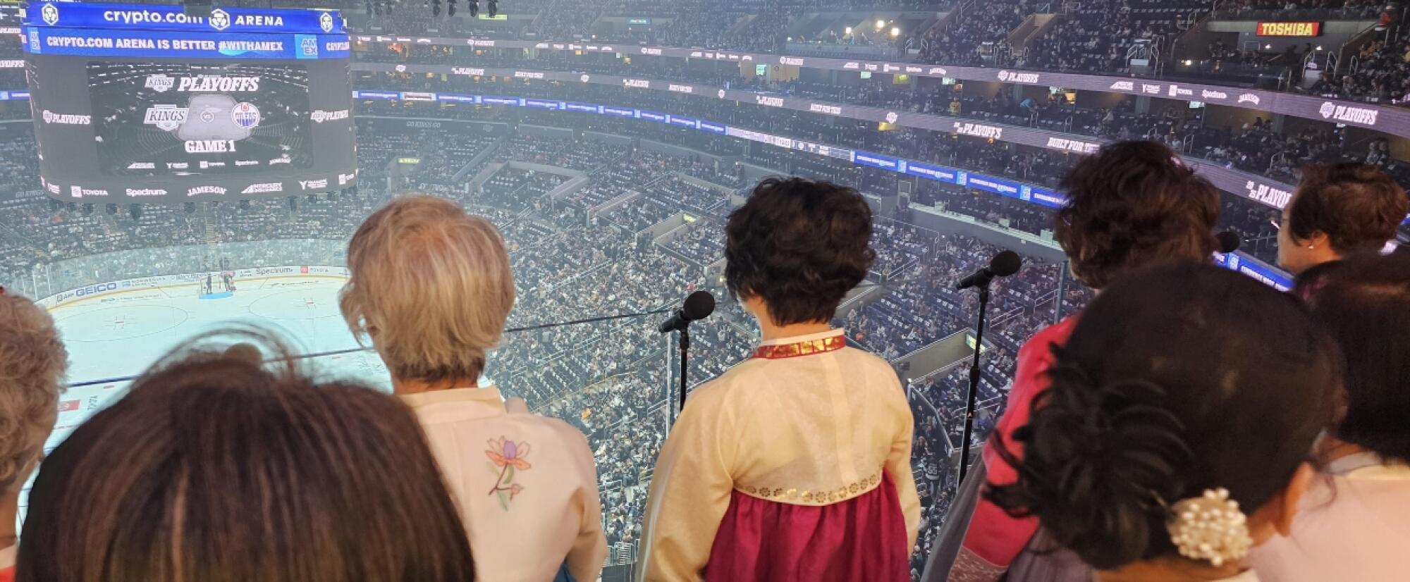 A view of the interior of Crypto.com Arena from behind members of the Koreatown Senior & Community Center's harmonica class