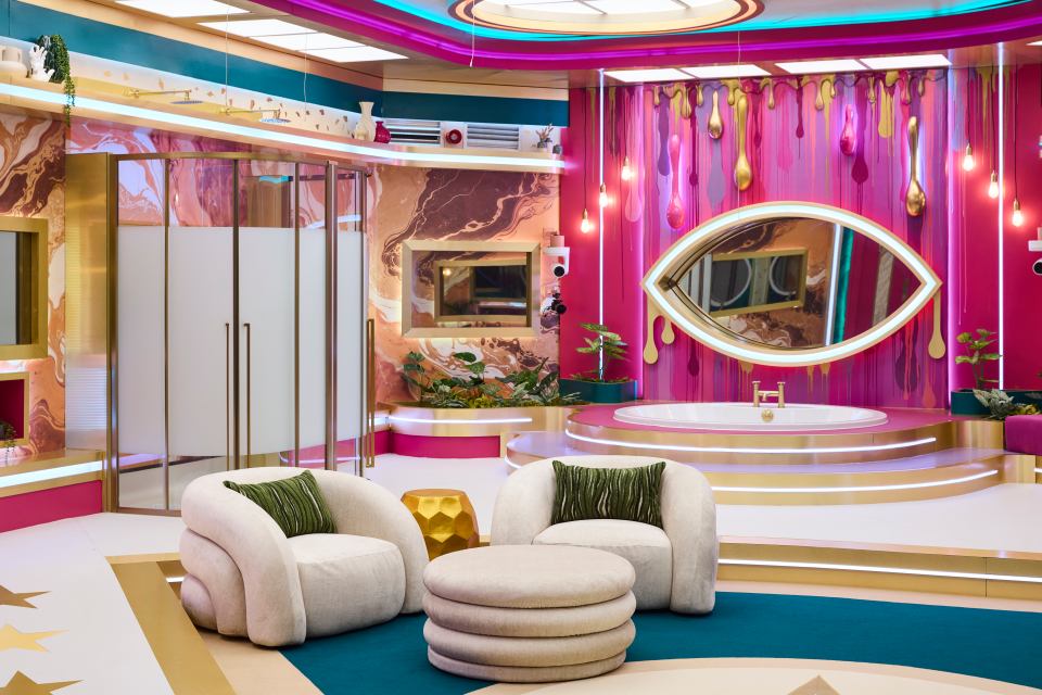 Image of a brightly colored bathroom with a large bathtub and two armchairs.