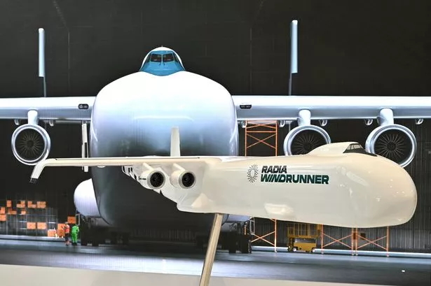 FARNBOROUGH, ENGLAND - JULY 23: A model of a Radia WindRunner, designed to transport wind turbine blades to remote onshore locations is displayed during the Farnborough International Airshow 2024 at Farnborough International Exhibition and Conference Centre on July 23, 2024 in Farnborough, England. A Colorado-based energy startup, Radia is developing the biggest aircraft in aviation history. The aircraft's function is to transport gigantic wind turbine blades to remote onshore wind farm locations. the aircraft will be able to run on 100% sustainable aviation fuel (SAF) and land on semi-prepared airstrips at wind farm sites. (Photo by John Keeble/Getty Images)