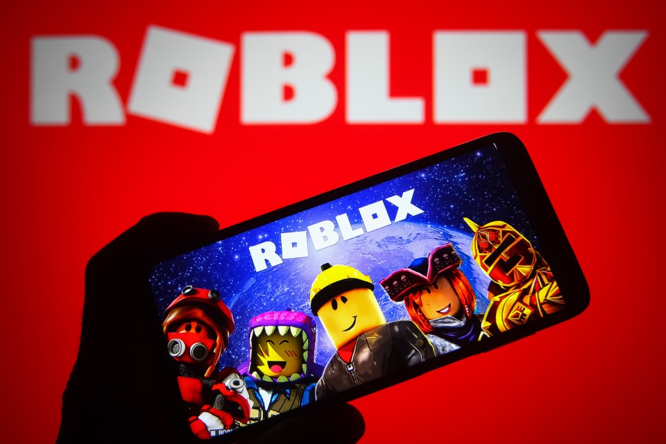 Photo illustration of the Roblox logo on a smartphone and PC screen.
