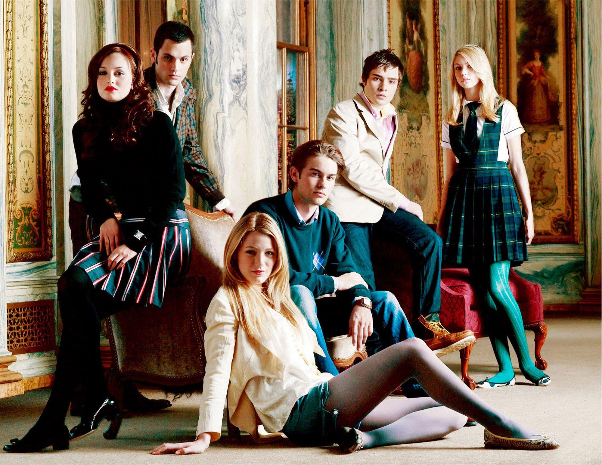 A group of young men and women sit and stand, looking sultry