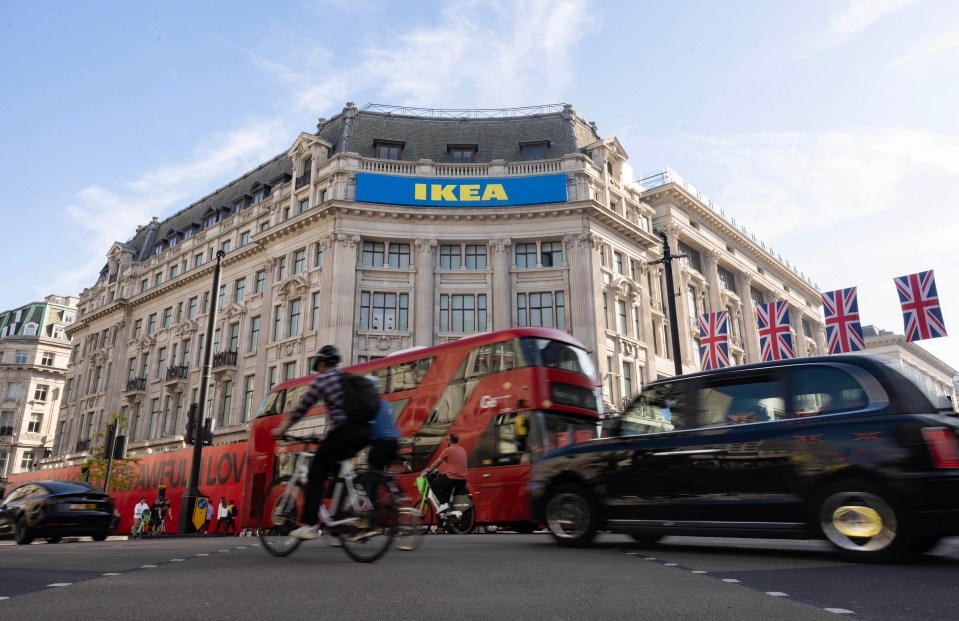 A cyclist rides past a new IKEA store on Oxford Street in London.