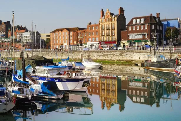 Clear skies, historical buildings, boats and canal