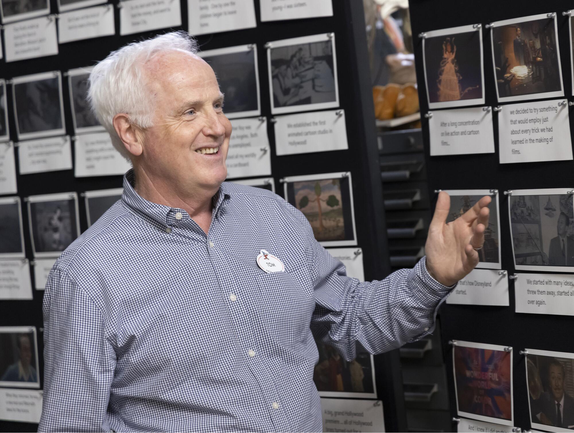 A Disneyland designer walks guests through storyboards.
