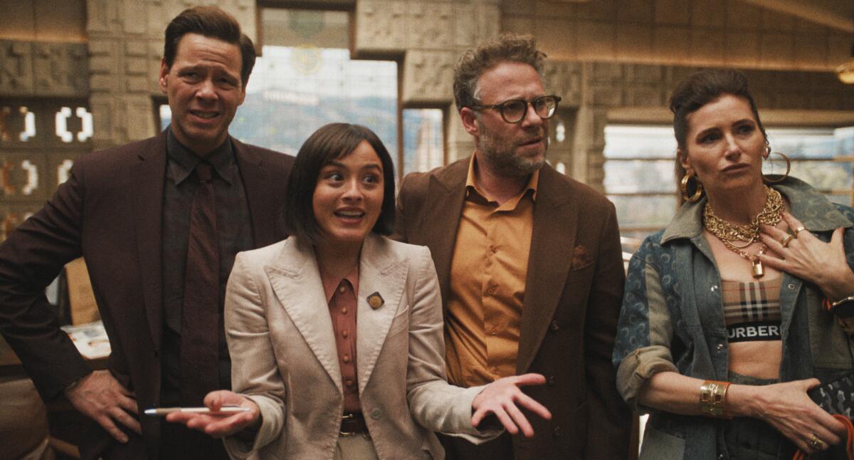 Two men and two women stand next to each other with confused expressions on their faces.
