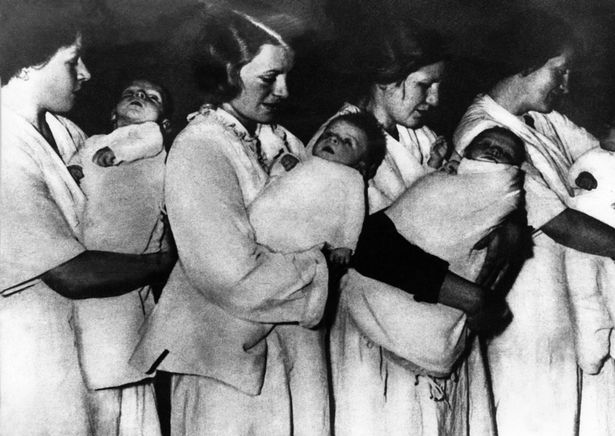 German women holding ‘Aryan’ babies in a  Lebensborn during the Second World War