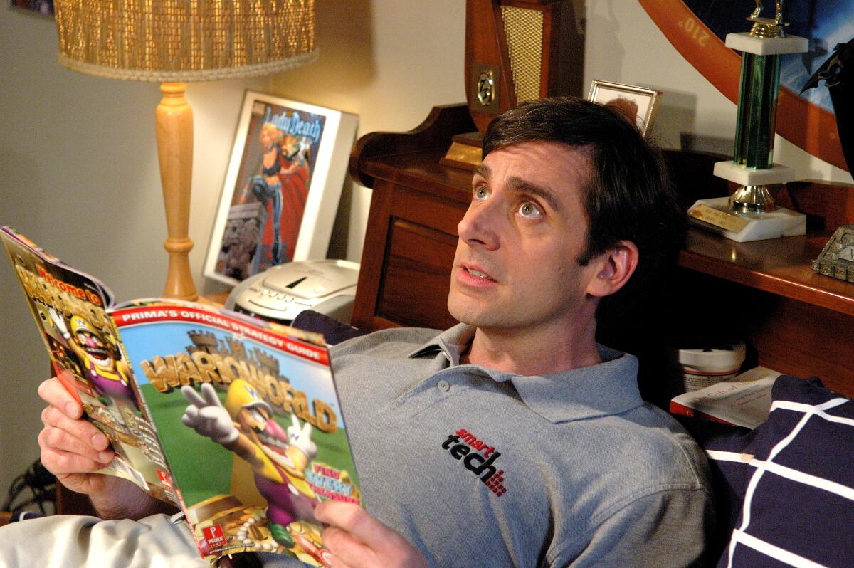 A grown man reads a comic book in bed.