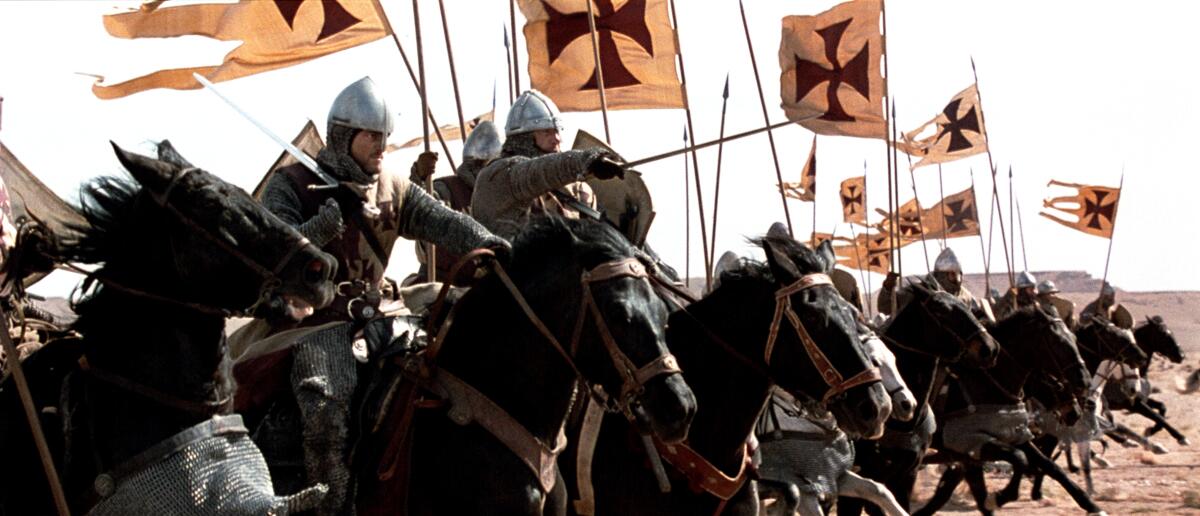 Mounted soldiers race into battle.