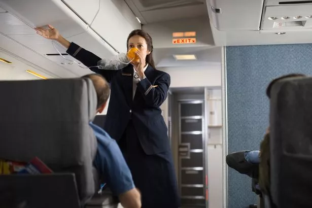 Image of flight attendant during safety demonstration