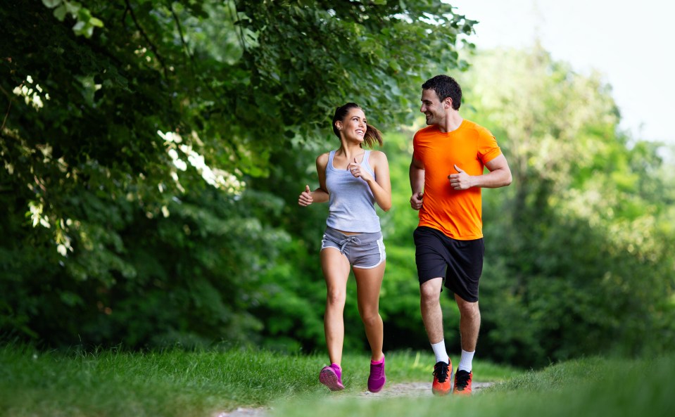 Happy couple jogging outdoors.