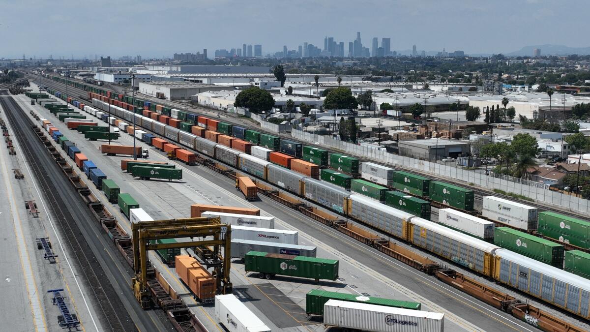 An aerial view of Commerce rail yard of trucks, trailers, containers, and trains moving goods.