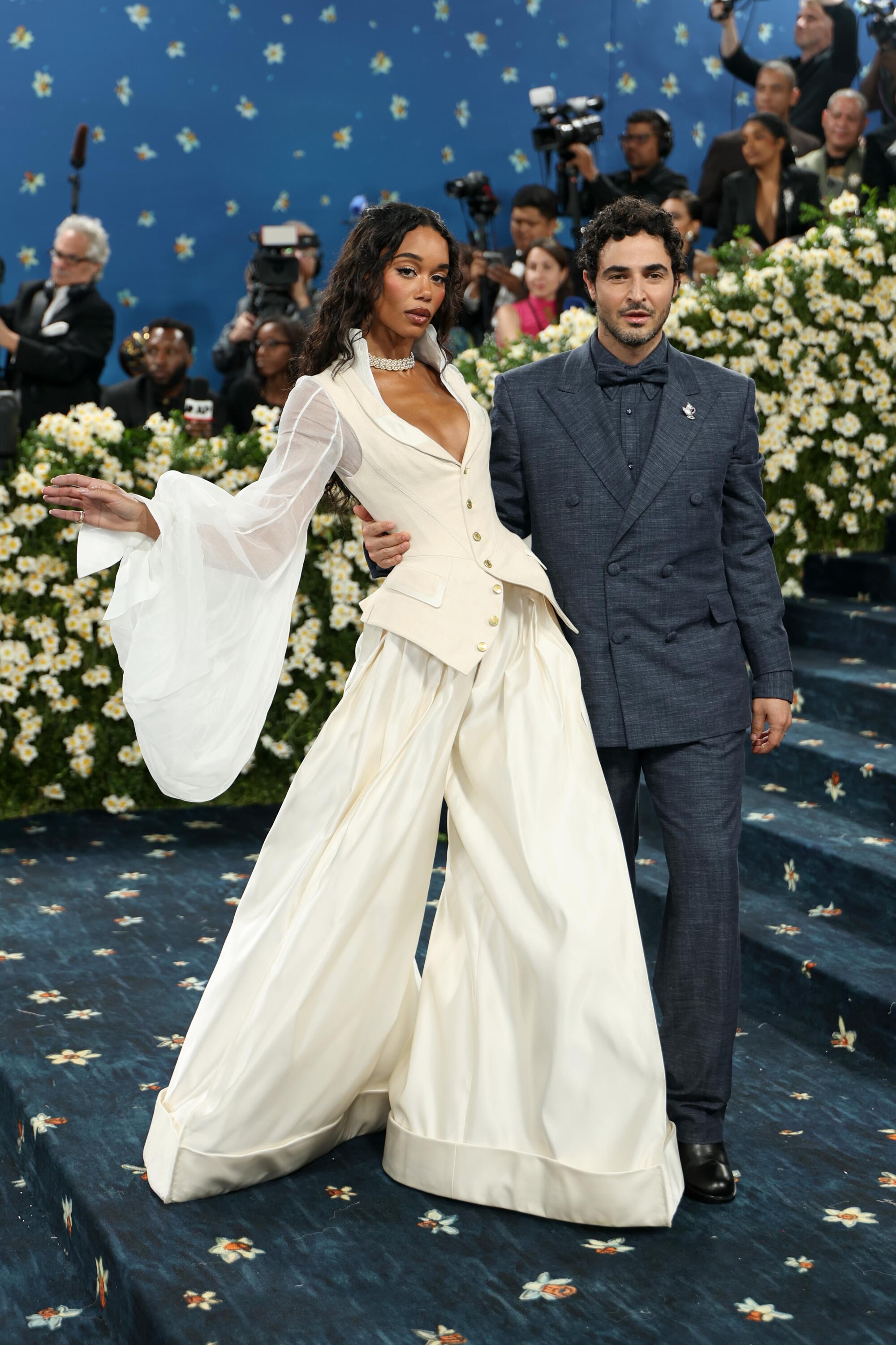 Laura Harrier wearing Ecru Gap, left, and Zac Posen.