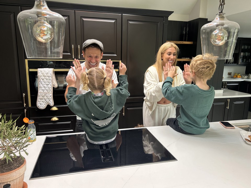 Family giving high fives in a kitchen.