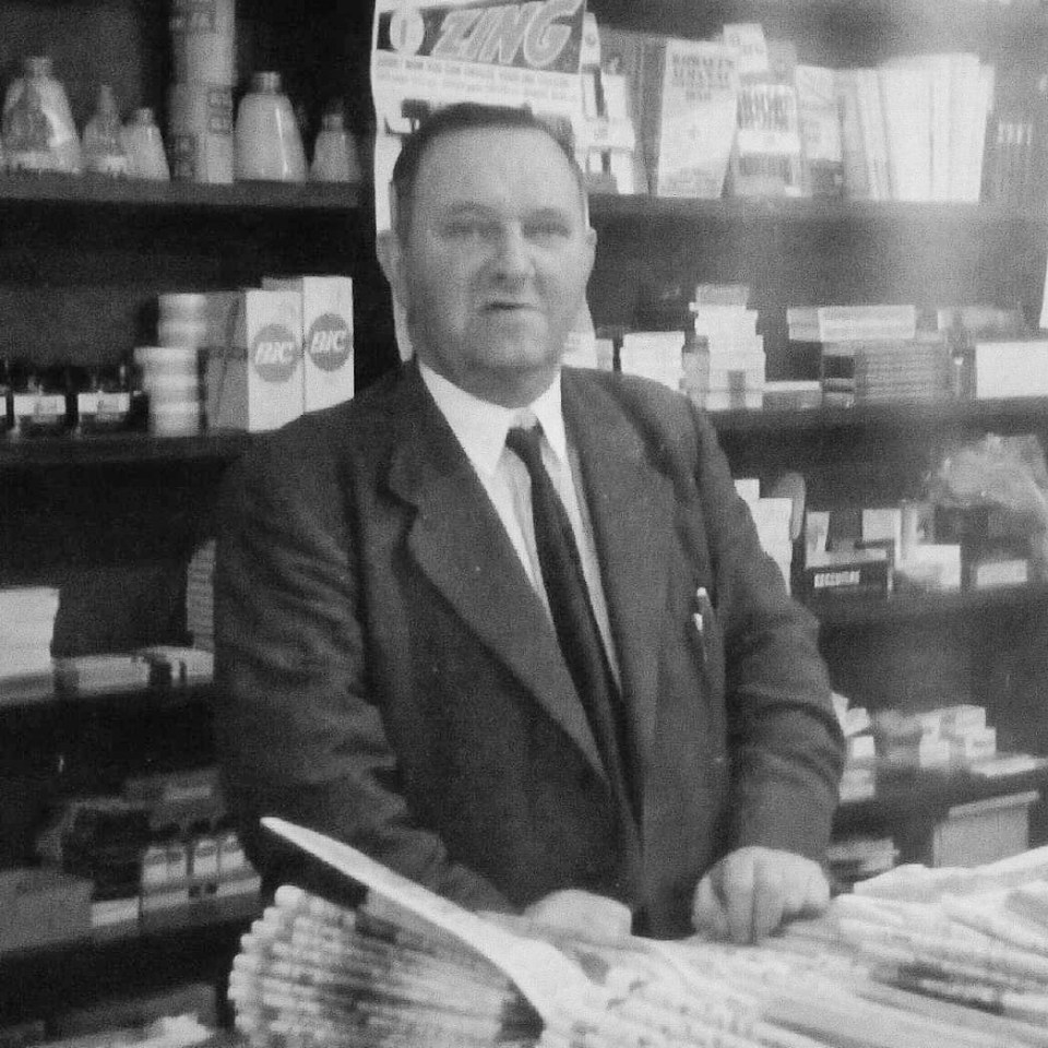 Black and white photo of Percy Burrows in his family's newsagents in Ely, Cambridgeshire in the 1950s.