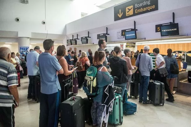 Image of passengers queuing at check-in at Lanzarote airport