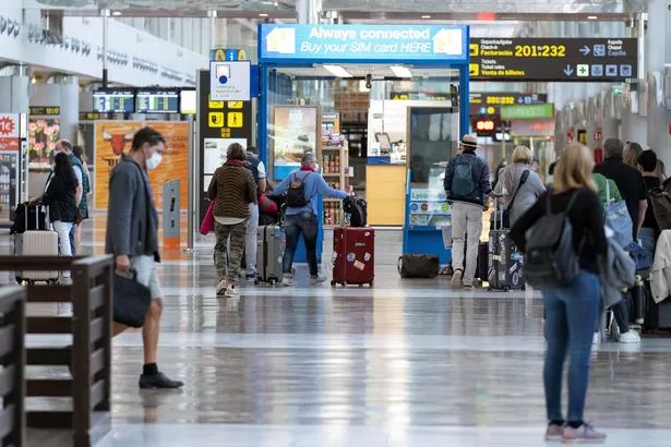 Image of travellers moving around an airport