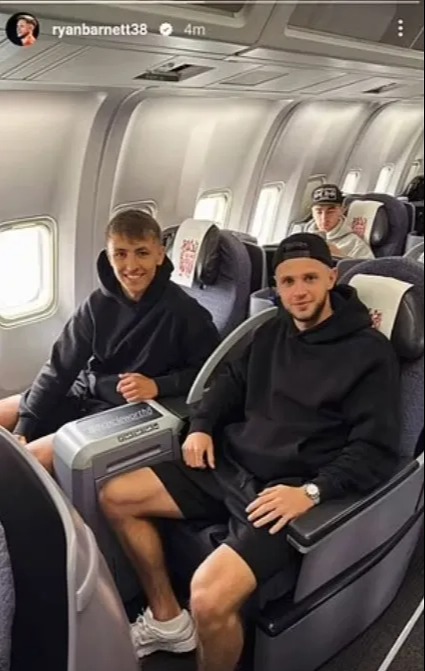 Three men sitting in airplane seats.