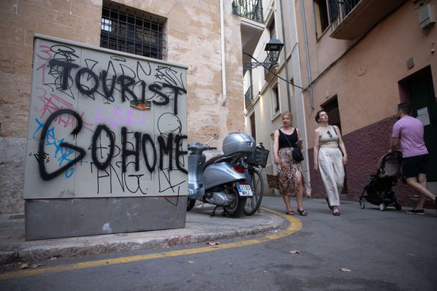 Anti-tourist graffiti reading "Tourist Go Home" in Palma de Mallorca, Spain, on Friday, July 26, 2024. Southern European cities including Lisbon and Madrid saw strong growth in residential-property values in the first half of the year, as an ongoing supply crunch buoyed the high-end housing market. Photographer: Andrey Rudakov/Bloomberg via Getty Images