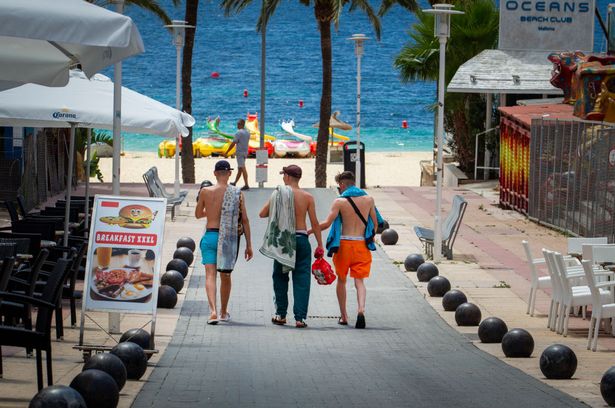 Tourists walk at General Garcia Ruiz street in Magaluf, Calvia, in Spain's Balearic island of Majorca on July 16, 2020. - Regional authorities on Spain's Balearic island of Majorca ordered the immediate closure of bars on three streets popular with hard drinking tourists to limit the potential for coronavirus outbreaks. (Photo by JAIME REINA / AFP) (Photo by JAIME REINA/AFP via Getty Images)