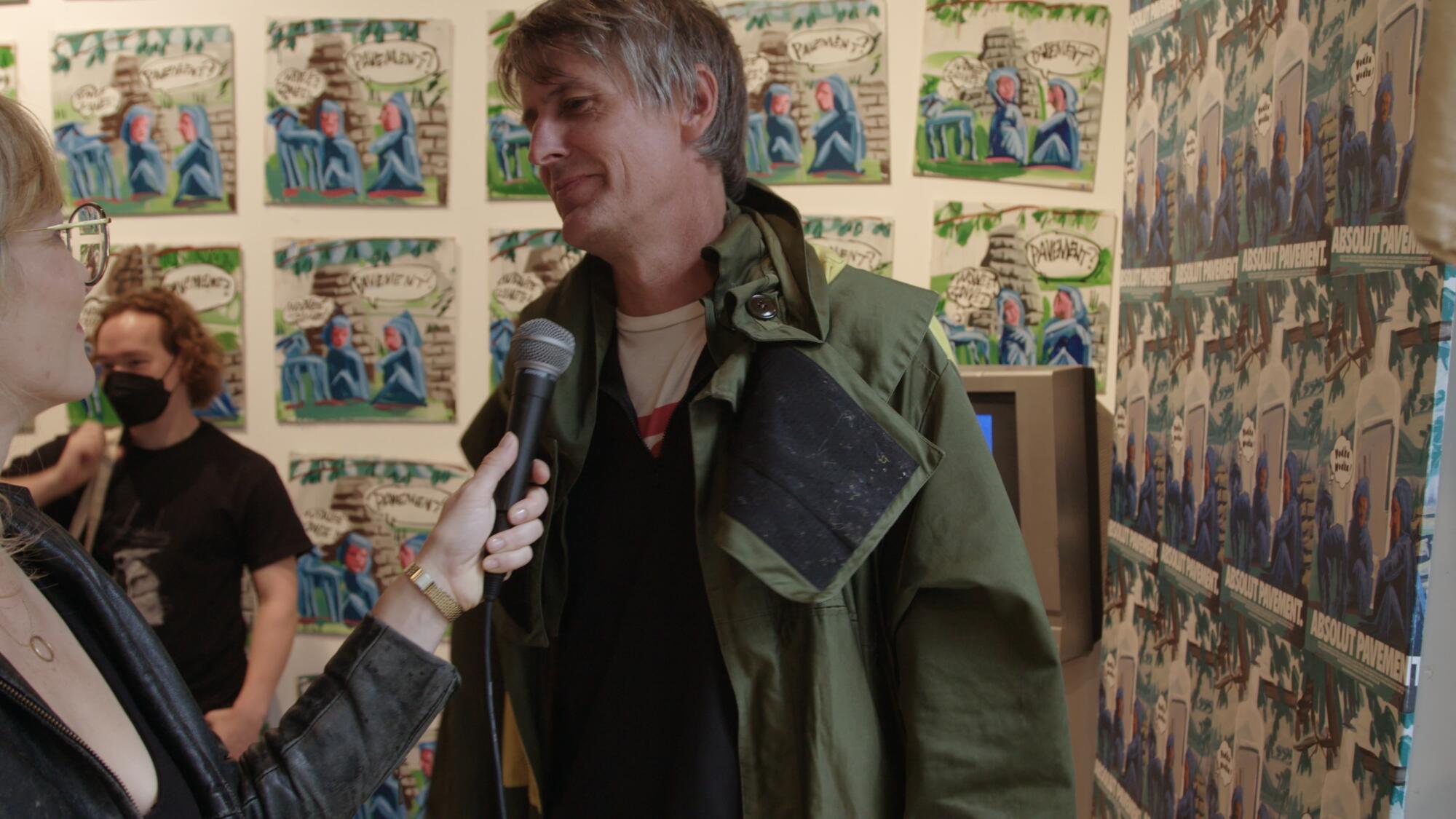 A smiling man is interviewed.