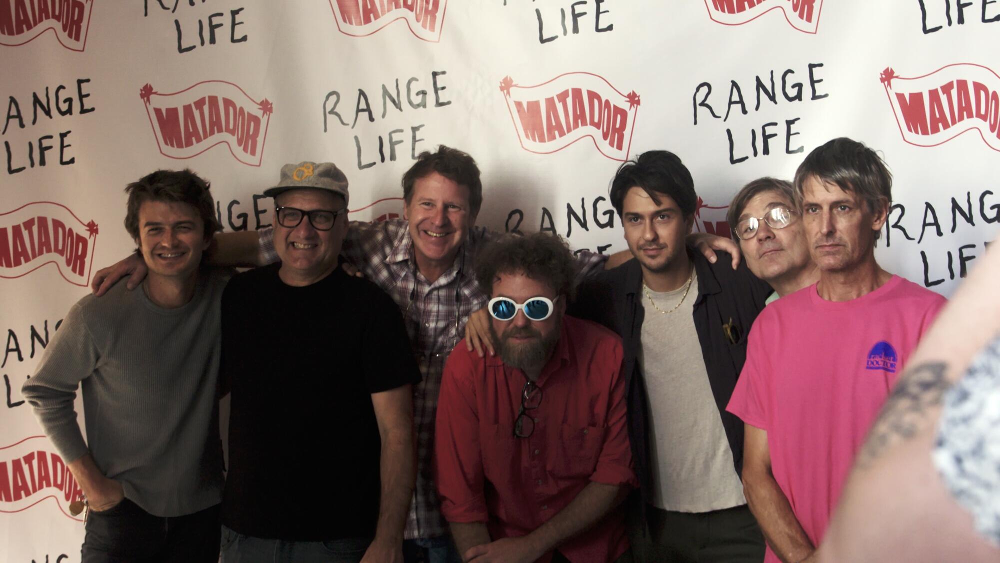 Several people pose for a photograph at a premiere screening.