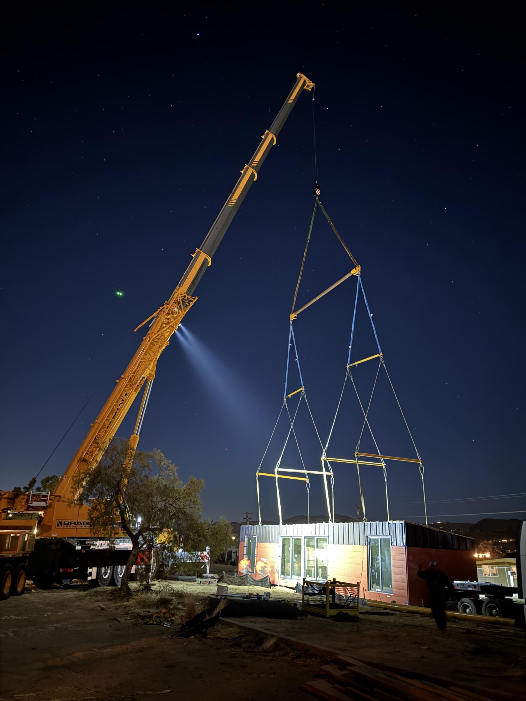 A crane sets one of Cassette's modular homes into place in Joshua Tree.