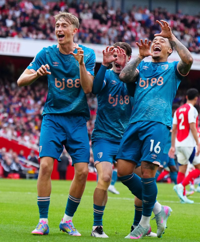 Three Bournemouth soccer players celebrating a goal.