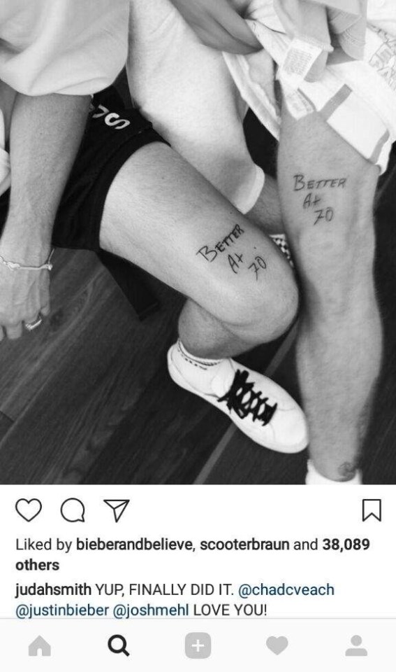 Black and white photo of Justin Bieber and Judah Smith's matching "Better At 70" leg tattoos.