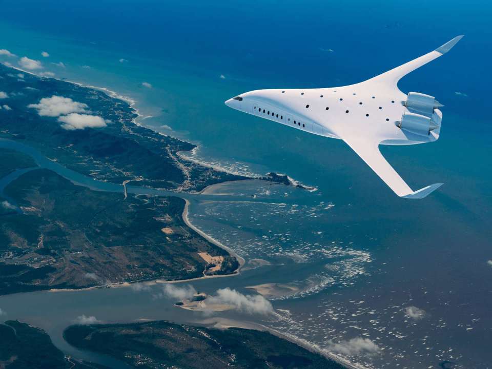 Futuristic airplane flying over coastal landscape.