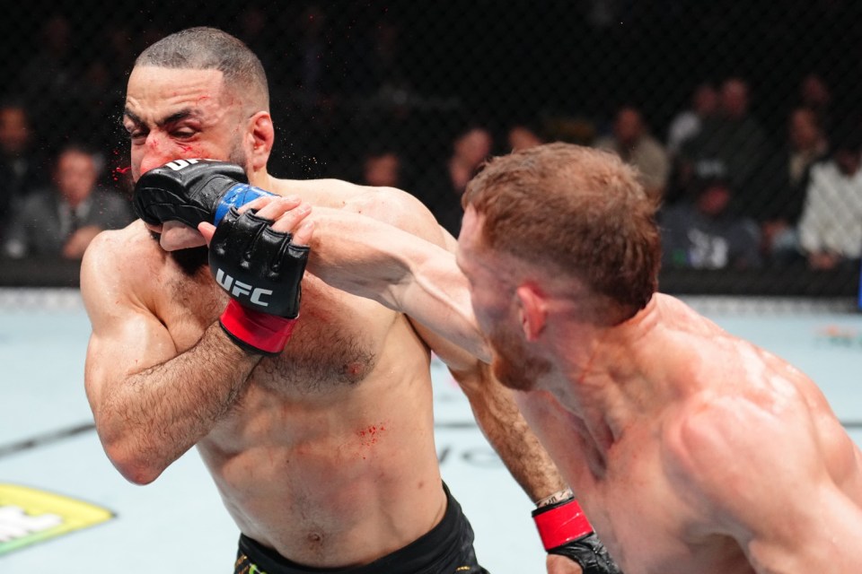 Jack Della Maddalena punches Belal Muhammad in a UFC welterweight championship bout.