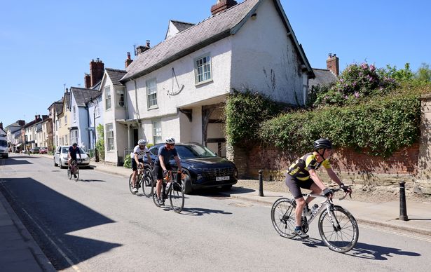 Presteigne street view with cyclists riding down the road
