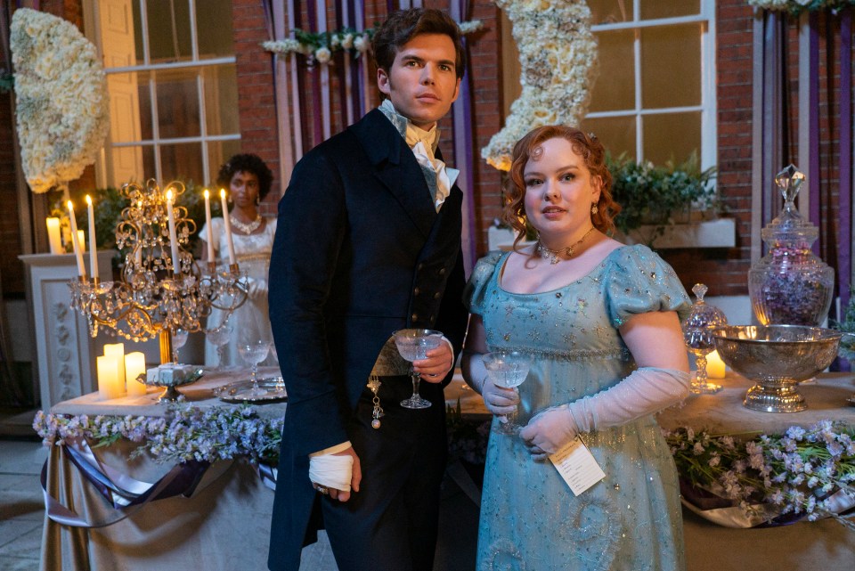 Luke Newton as Colin Bridgerton and Nicola Coughlan as Penelope Featherington in Bridgerton.