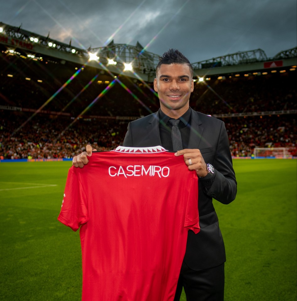 Casemiro holding a Manchester United shirt.